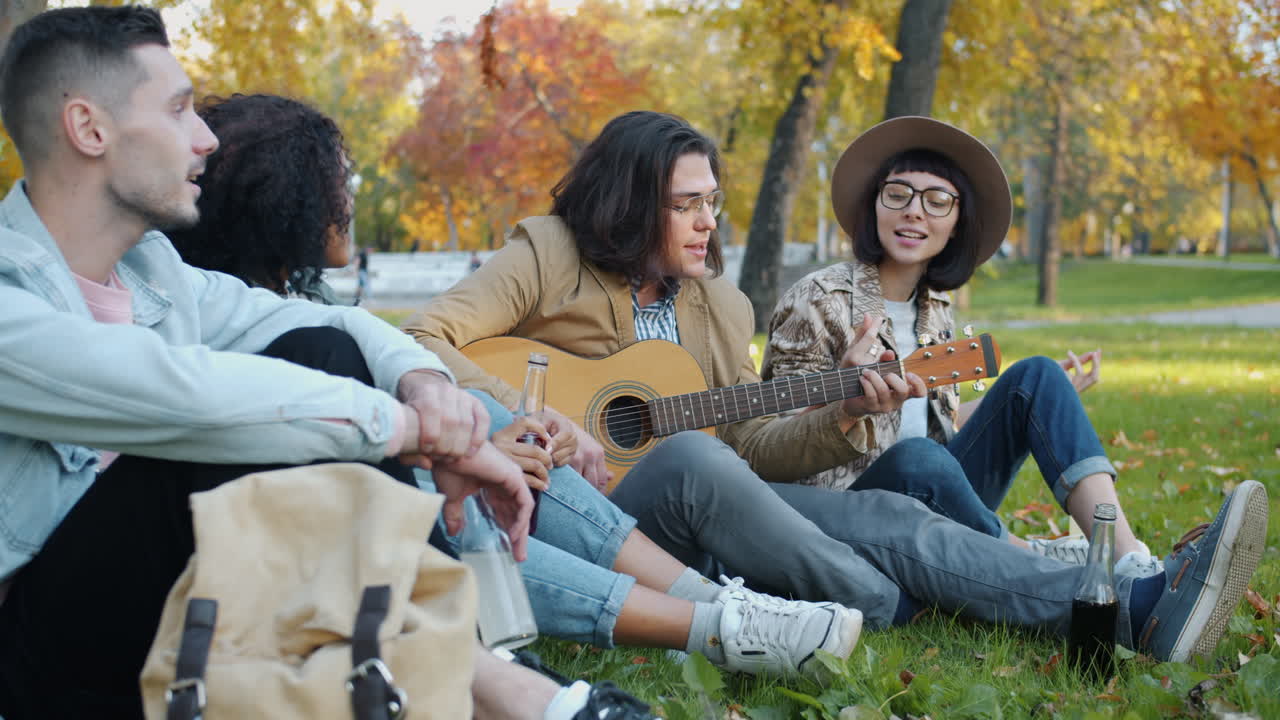 Friends Playing Guitar in the Park