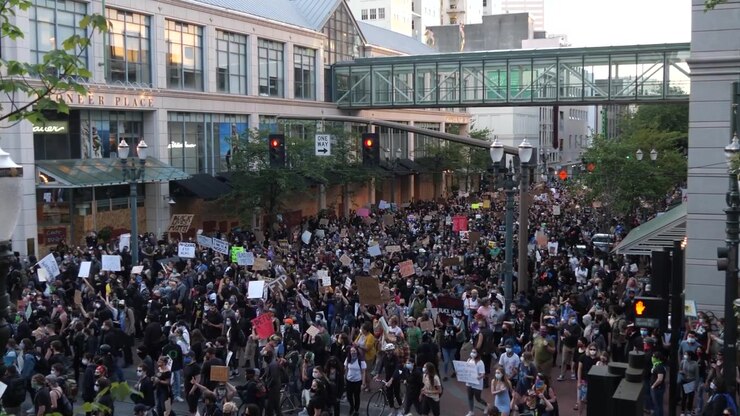 A crowd of protesters march in Portland Oregon to protest the killing of George Floyd by police.