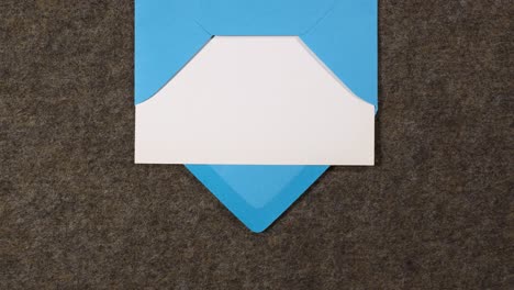 blue letter envelope containing a white paper enters and exits the scene from the top of the screen