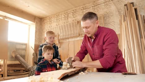father and sons learning woodworking