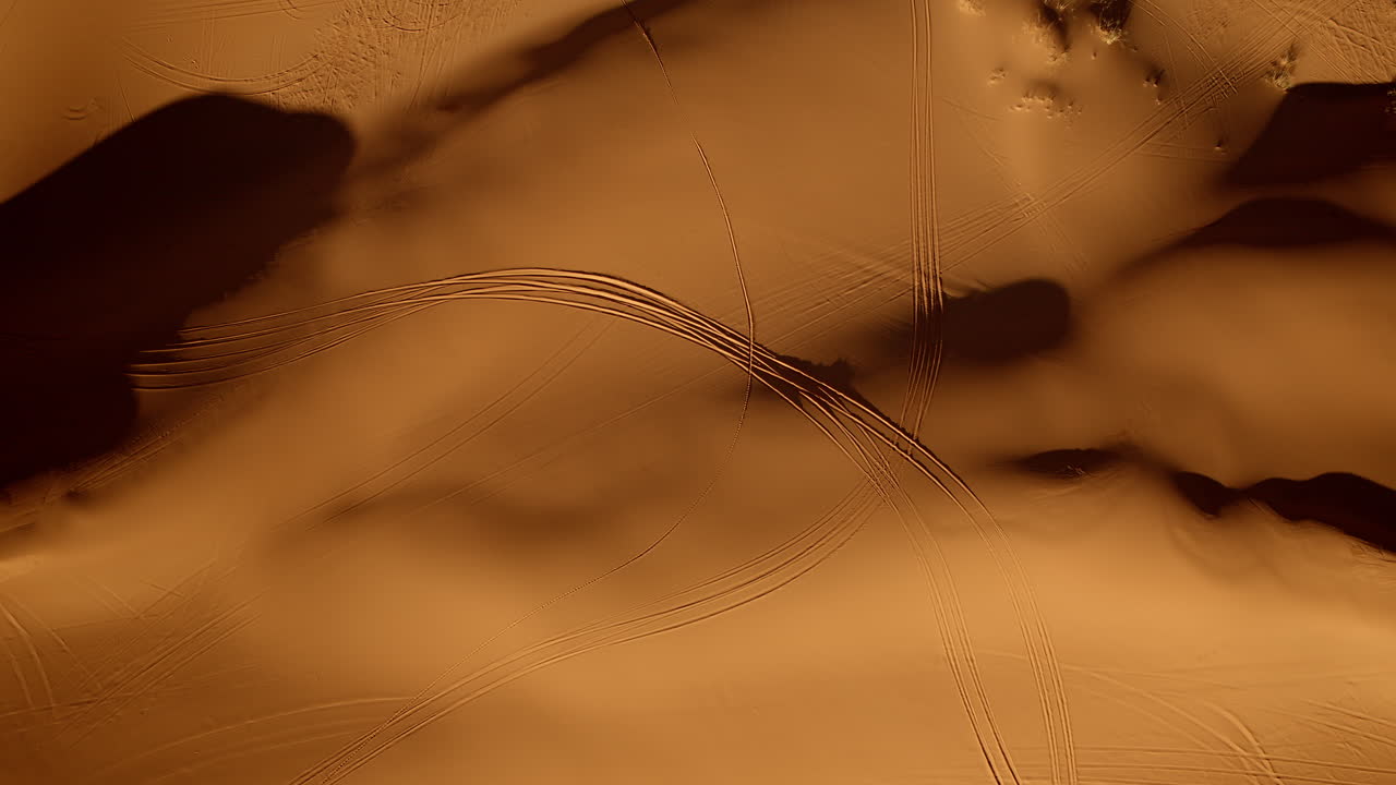 From above, pink sand dunes swirl with brilliant colors and forms in southern Utah’s landscape.