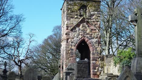 Historic-Windleshaw-Chantry-stone-tower-exterior-slow-motion-around-ruins-against-blue-sky