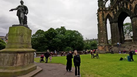 people gather around scott monument in edinburgh