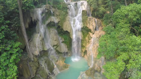 aerial over a small tropical waterfall in a jungle setting