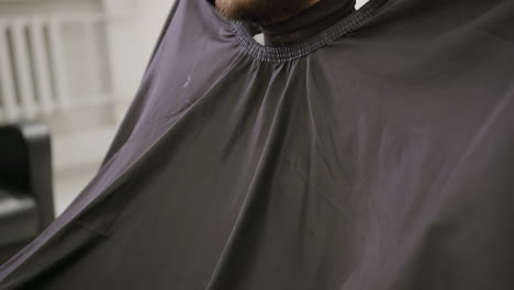 barber preparing a customer for a haircut