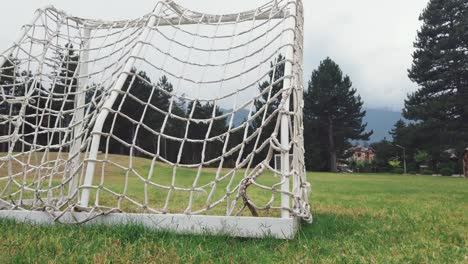 portable mini football goal with the white mesh on a green lawn