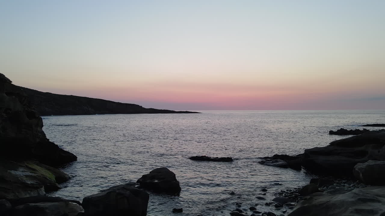 Free stock video - Zoom in of sea waves breaking on rocks at sunset