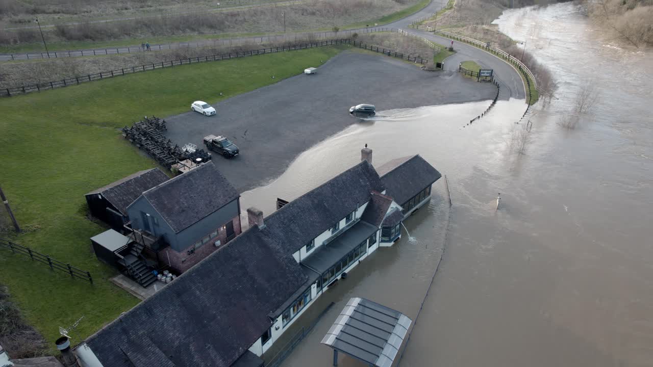 River Severn busts its banks and floods pub water pumped out drone view UK