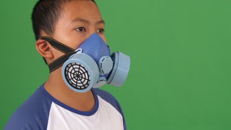 asian boy wearing pollution mask, green screen