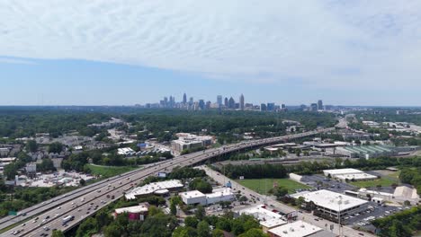 drone shot pushing in on the atlanta skyline and highway on a summer day