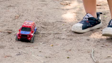 child playing with a toy car outdoors