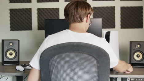 boy walking to his gaming setup to pick