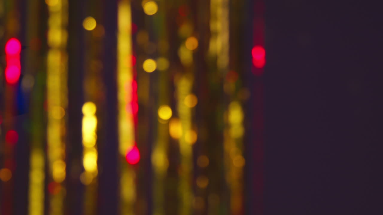 Shot Of Defocused Tinsel Curtain In Night Club Or Disco