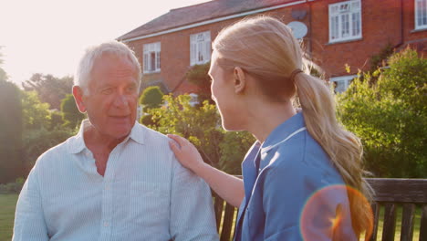 nurse talking to senior man in residential care home