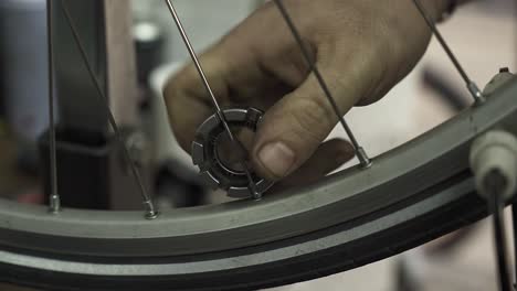 a bicycle mechanic aligning a bicycle wheel