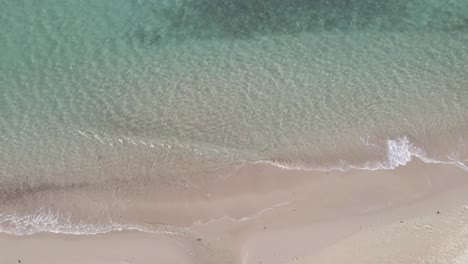 top down view aerial white sand beach with clear ocean water small waves