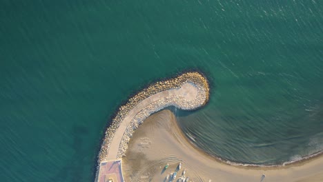 graphic top view smooth drone shot above seashore in candado malaga, spain