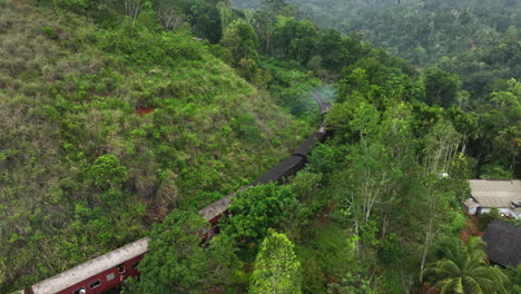 Aerial-view-following-a-train-on-the-famous-Kandy-to-Ella-railway,-in-Sri-Lanka