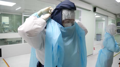 medic staffs putting on papr suits before entering covd-19 ward