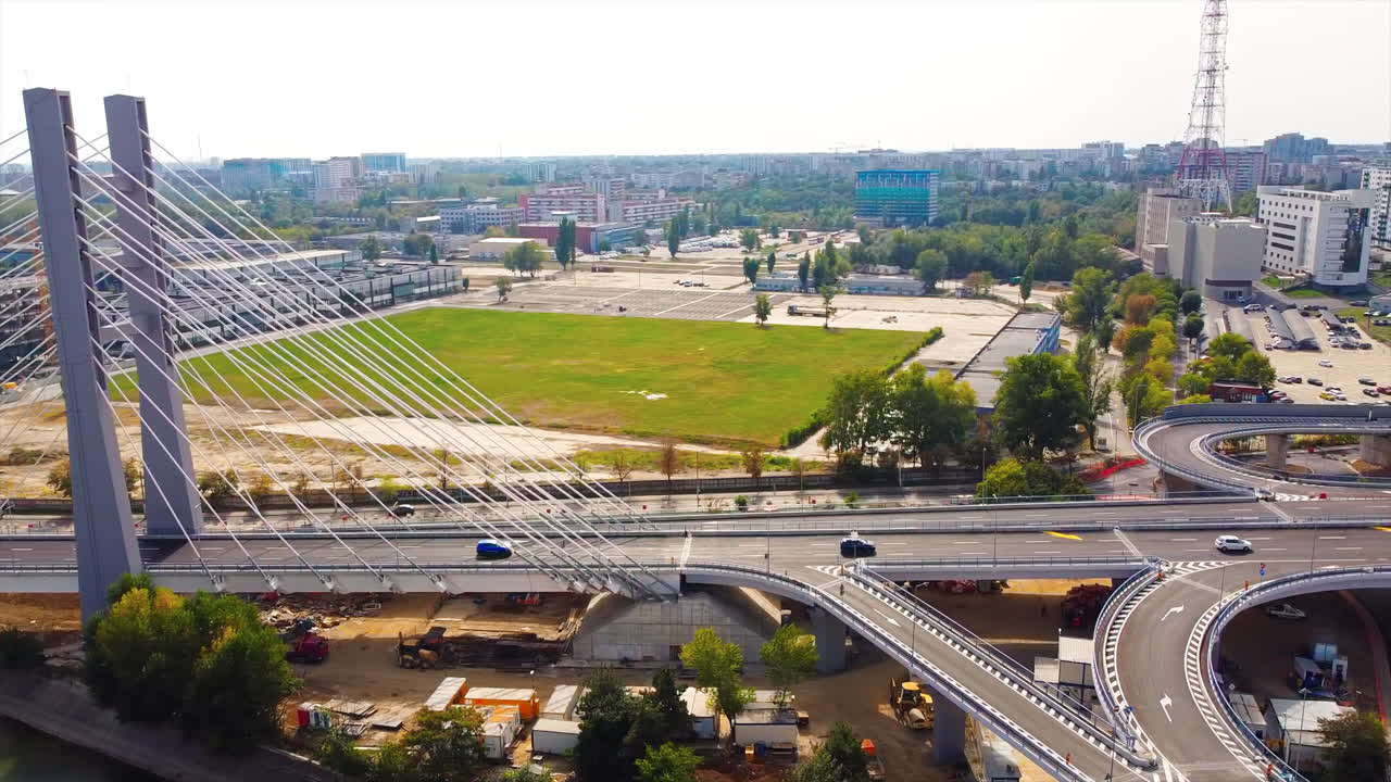 Ciurel passage, bridge over a river with moving cars, recreational complex, lake. View from the drone. Bucharest, Romania