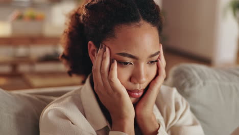 woman sitting on a sofa looking sad