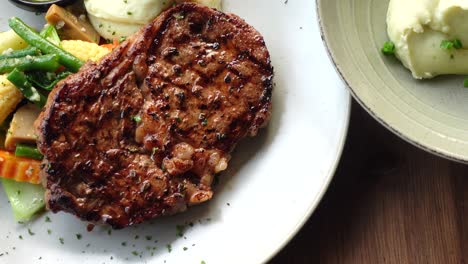 grilled steak with mashed potatoes and vegetables