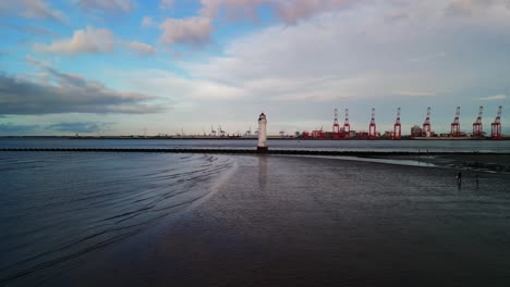 New-Brighton-Perch-Rock-Lighthouse,-River-Mersey,-Wirral---aerial-drone-low-approach,-Liverpool-waterfront-backdrop-on-a-sunny-winter-afternoon-08