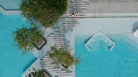 aerial view couples walking near the pool