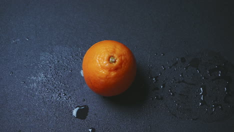 knife knocking top off of orange, slicing in half, fresh fruit