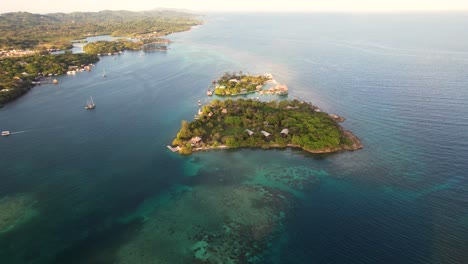 Aerial-top-view-of-tropical-island-and-colorful-reef-,-Oak-Ridge-in-Roatan-island,-Atlantida,-Honduras