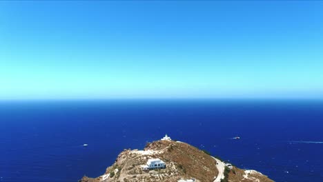 aerial 4k blue sea and sky top view towards distant akrotiri leuchtturm in santorini greece