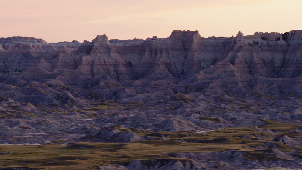 Glorious Evening Glow Washing Over Jagged Badlands From the Air