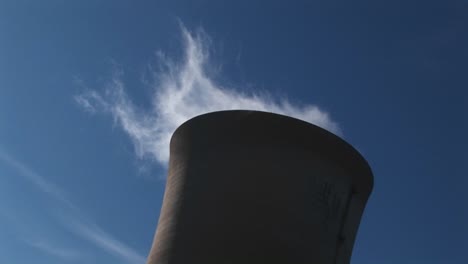 steam slowly dissipates from the top of a nuclear power plant