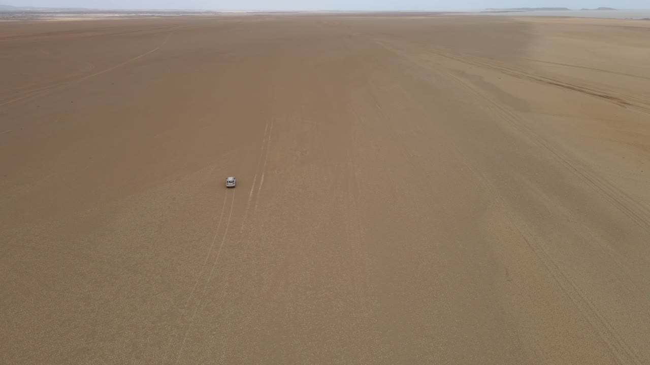Driving jeep Colombia desert empty land remote isolated La Guajira peninsula aerial view
