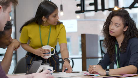 Tracking-In-To-Businesswoman-Presenting-To-Colleagues-Meeting