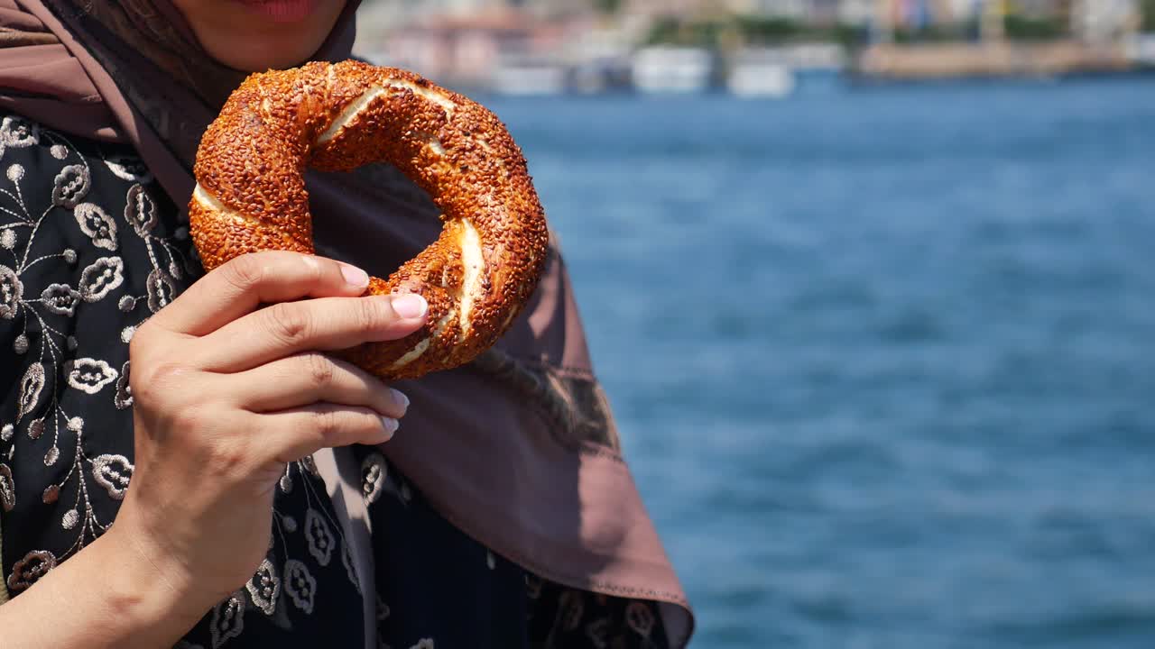 Woman holding a simit in Istanbul