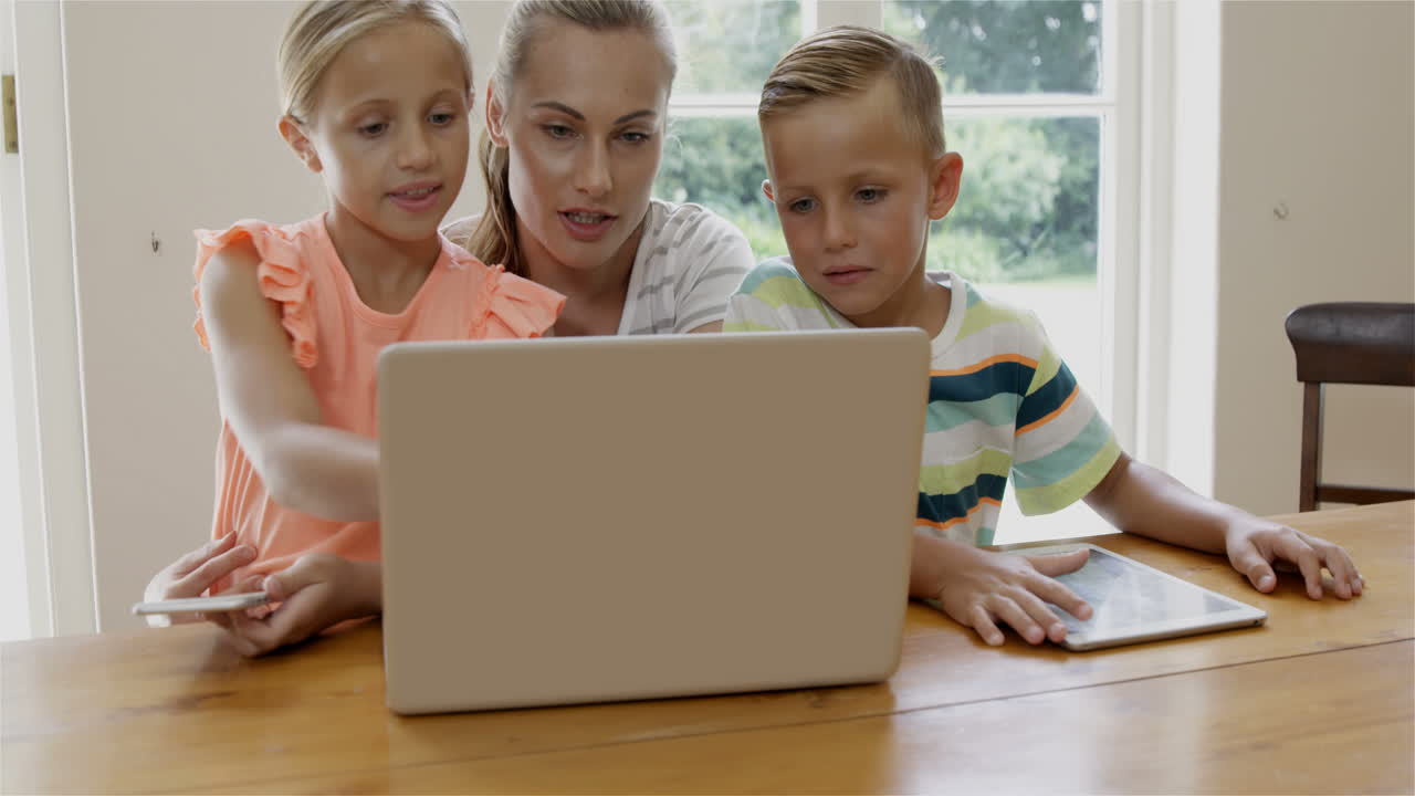 Mother and children using laptop