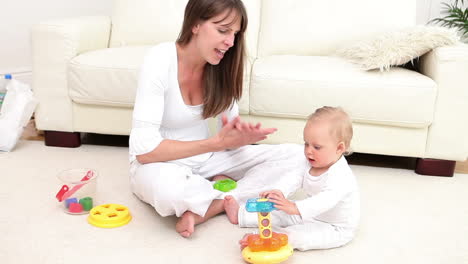 woman and a baby playing with a toy