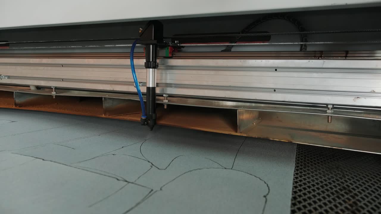 CNC machine for cutting fabrics textile materials and leather, laser marking and measurement. Modern footwear production.