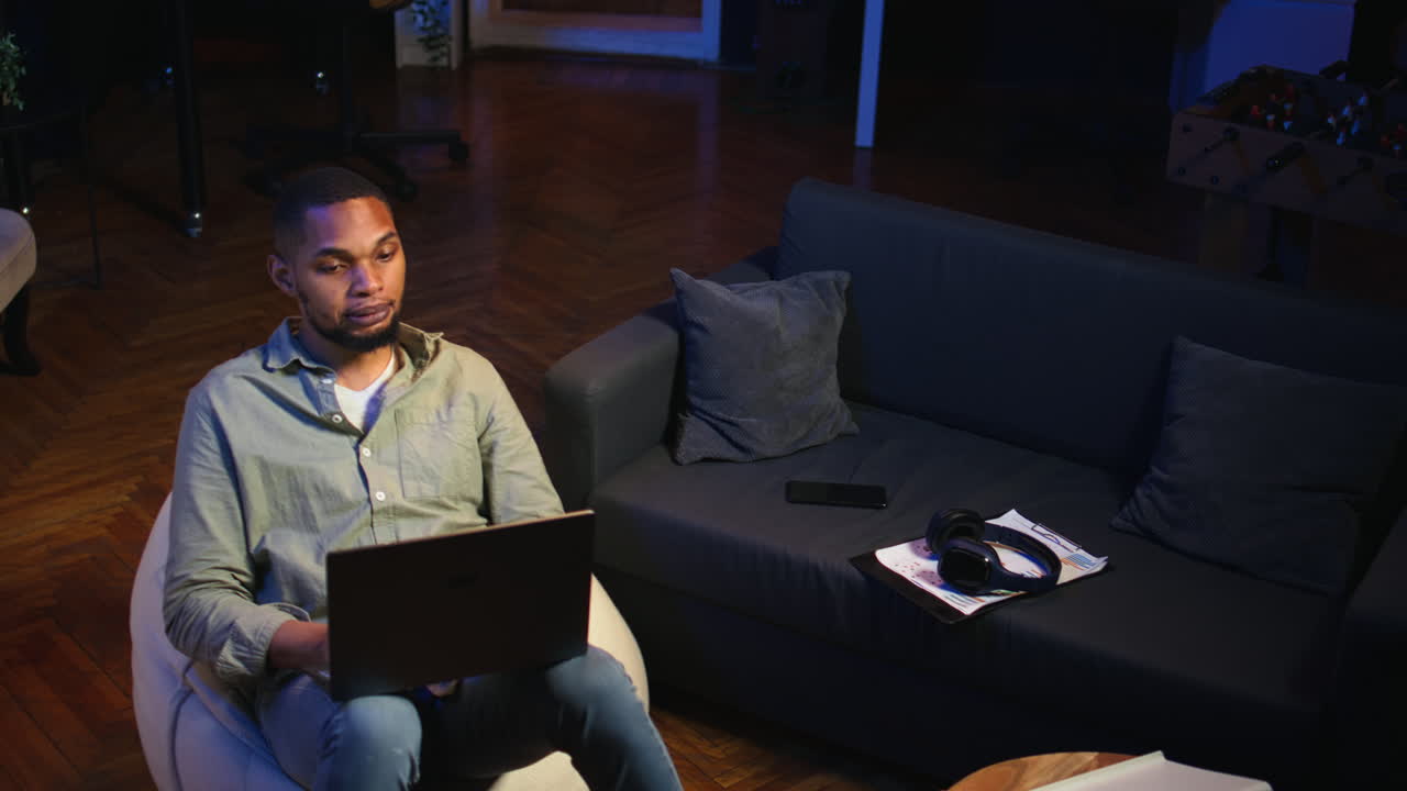 Vertical Video Black man joining online lesson to work on new skills from home space