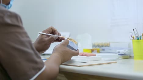 closeup shot for a technician preparing a denture