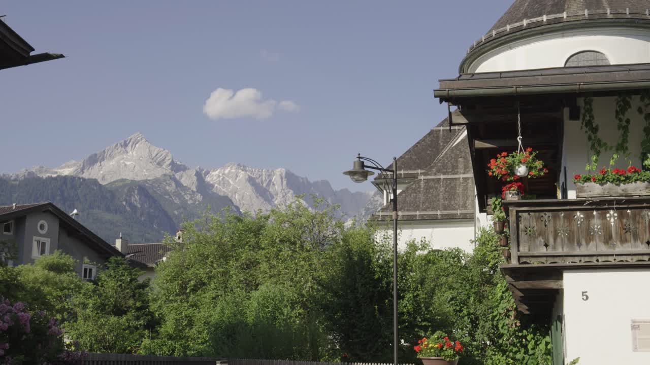 Alpine Farmhouse Style Building With Nature Surround And Mountain In Background