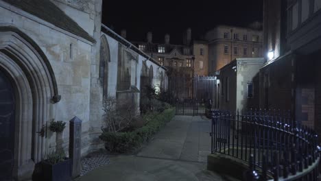 view of narrow street passage in cambridge city centre england uk during the night