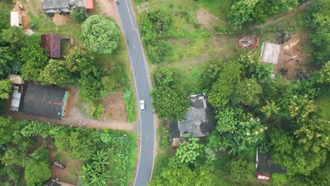 Fast-moving-aerial-overhead-shot-following-a-car-through-Handaganawa-in-Sri-Lanka