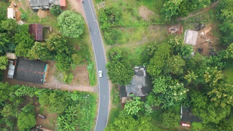 fast-moving aerial overhead shot following a car through handaganawa in sri lanka