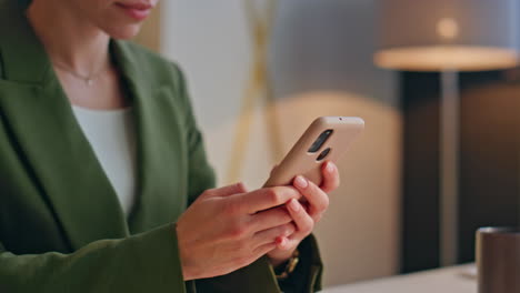 closeup businesswoman fingers texting phone at office workplace. lady working
