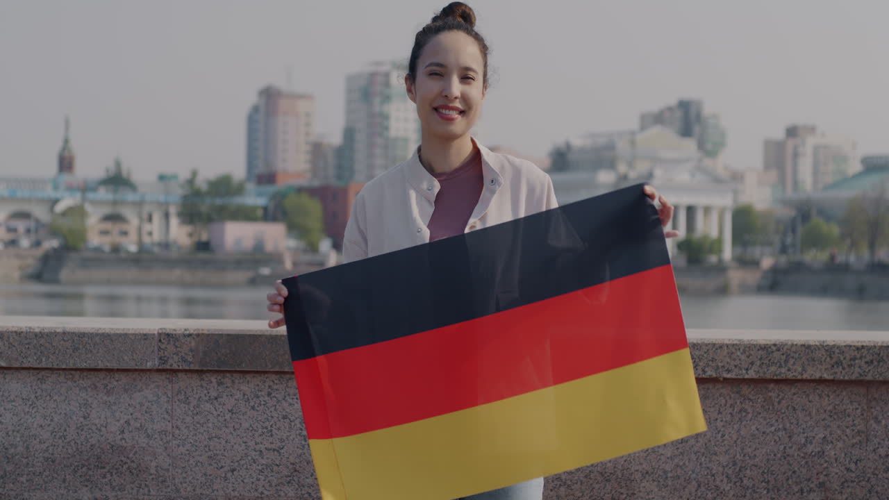 Woman holding German flag in city