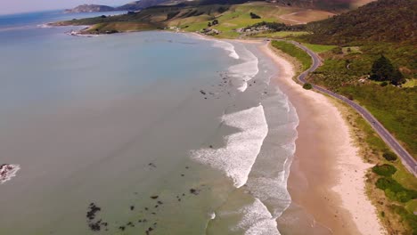 Road-on-New-Zealand-coast-reveal-beautiful-landmark-aerial-drone-shot