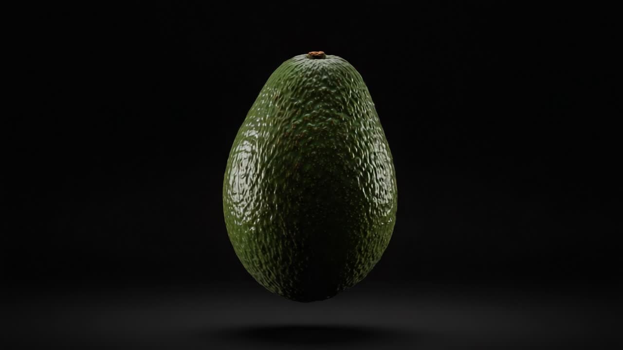 Una rappresentazione affascinante di un avocado sospeso su uno sfondo scuro, che mette in risalto la sua texture e forma uniche in due fotogrammi da una straordinaria presentazione visiva