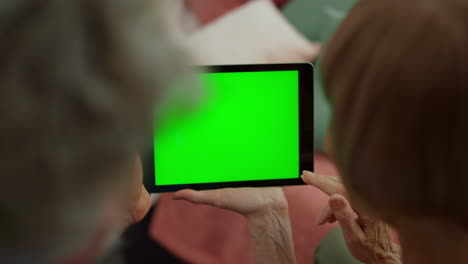 vista aérea de la mujer y el hombre mayores con las manos usando una tableta digital con pantalla verde